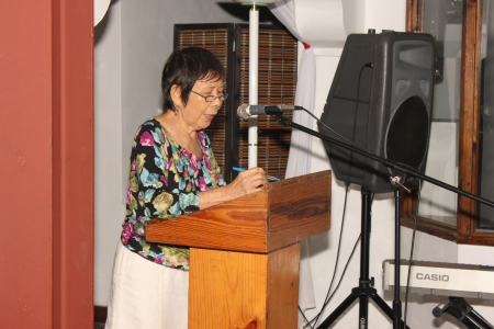 Joan Dayal says a few welcoming words to the gathering.